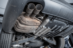 Vehicle suspension system repair showing undercarriage components.