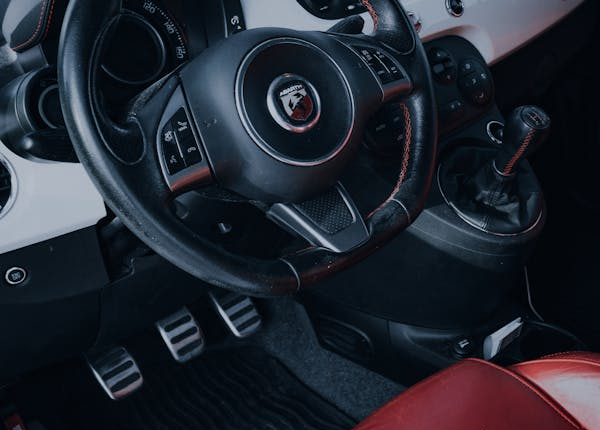 Interior view of a car dashboard and steering wheel for clutch repair.