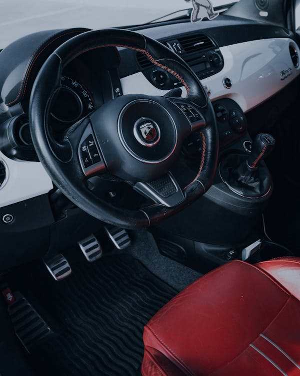 Interior view of a car dashboard and steering wheel for clutch repair.