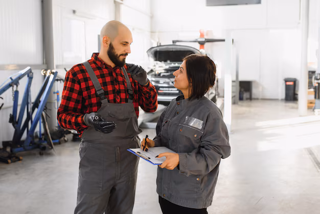 male-female-mechanics-working-car