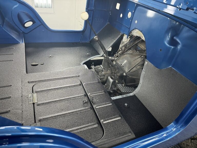 Interior view of a classic car being restored at John's Automotive.
