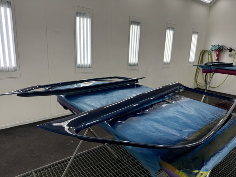 Custom car parts being restored at John's Automotive.