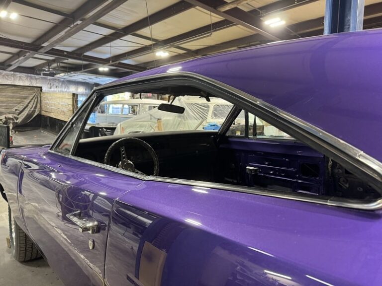 Vintage purple muscle car undergoing restoration at John's Auto Restorations.