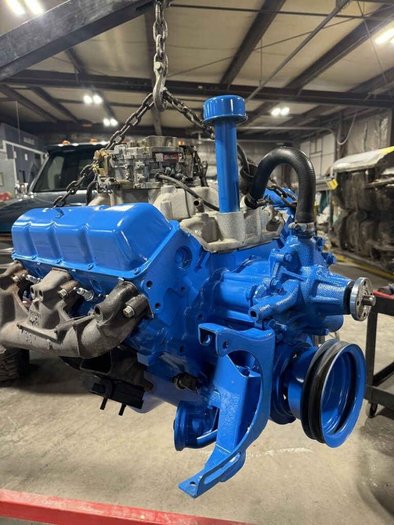 Engine being lifted for restoration at John's Automotive.