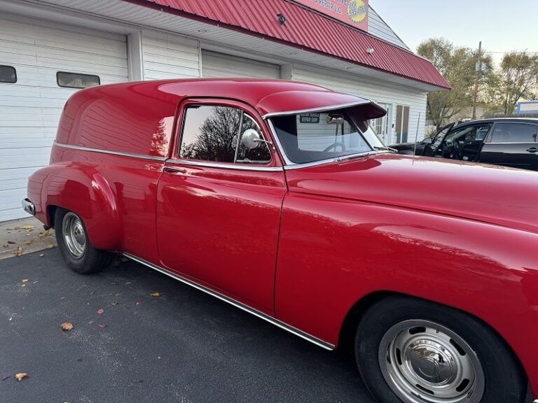 Vintage red classic car restoration at John's Auto Restorations, specializing in vintage vehicle rep.