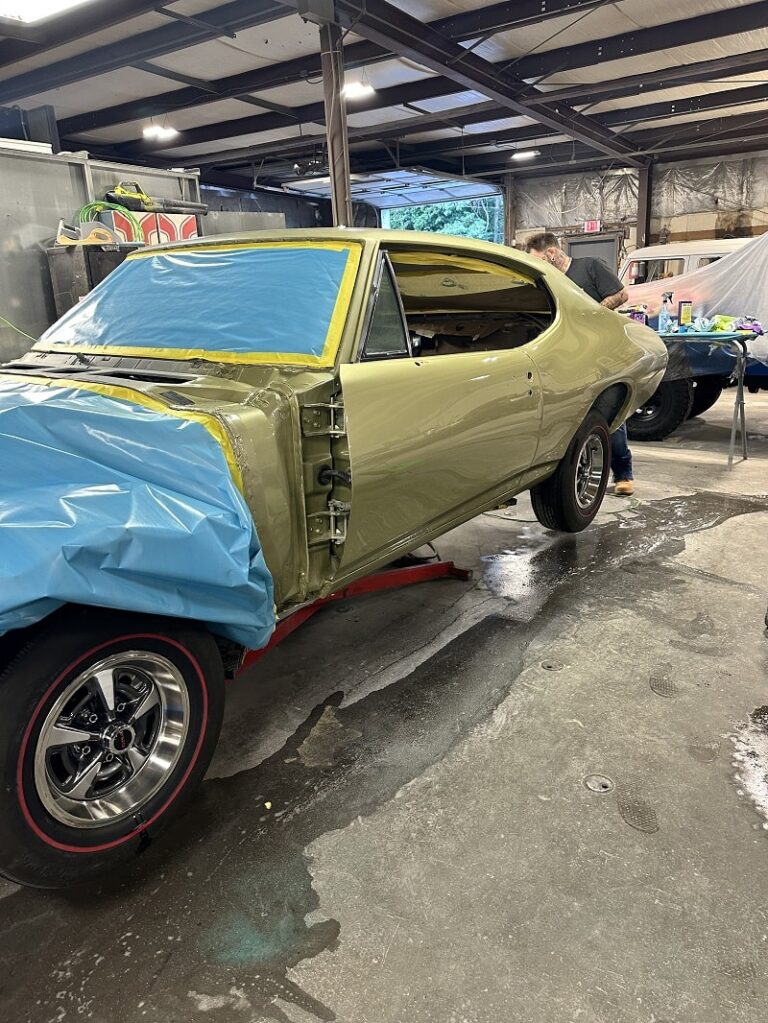 Vintage muscle car being restored in John's Auto Restorations workshop.