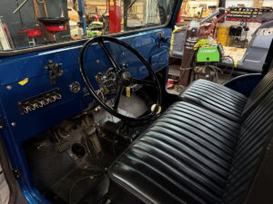 Interior view of a vintage vehicle at John's Auto Restorations workshop.