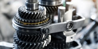 Close-up of automotive gear mechanism showing gears and mechanical parts.