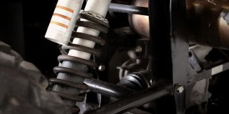 Close-up of vehicle suspension components at Kabayan Auto Repair LTD.