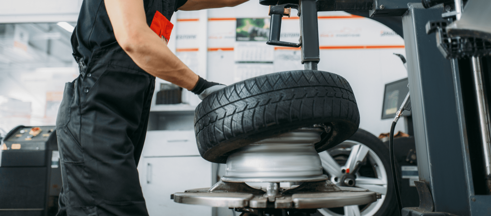 Technician rotating a car tire during maintenance at Kerrigan's Automotive.