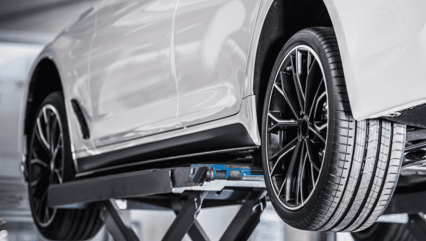 Modern car suspension system on a white vehicle at Kerrigan's Automotive.