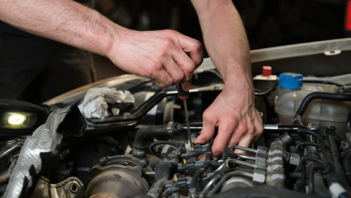 Engine repair technician diagnosing car engine issues.
