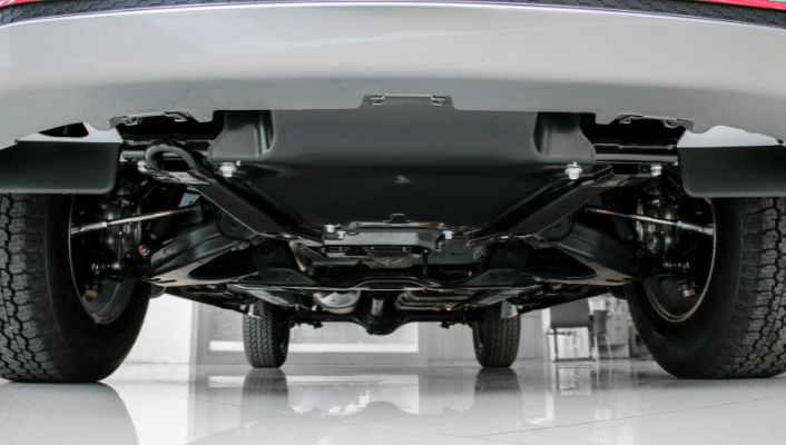 Undercarriage view of a car showing suspension and exhaust system for maintenance.