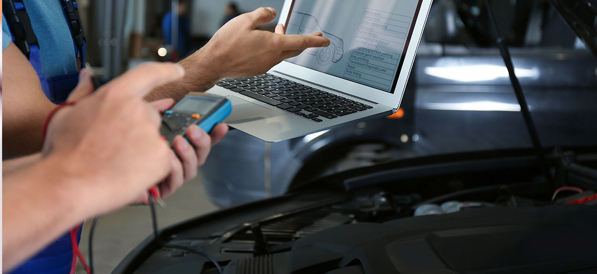 Automotive technician analyzing vehicle data through laptop