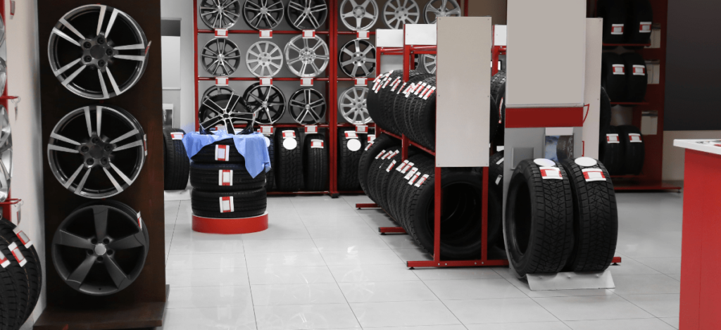 Wide view of tire racks with various car tires at K Tire Pro store.