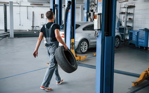 mechanic-holds-tire-repair-garage