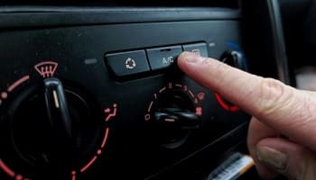 Auto climate control panel with temperature and airflow settings.