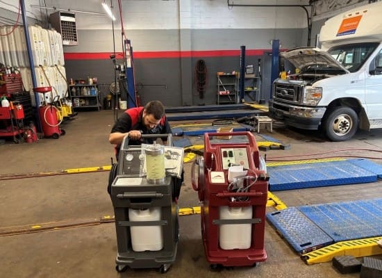 Auto repair technician inspecting equipment at tire shop.