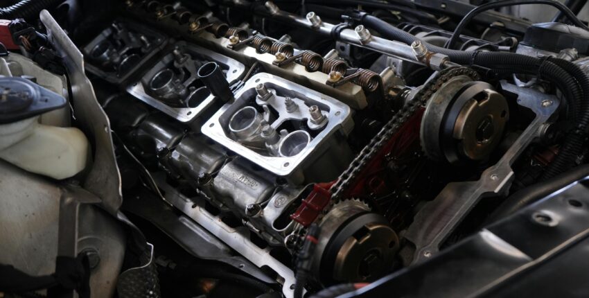 Car engine undergoing repair, emphasizing importance of regular brake inspections.