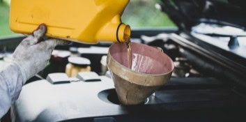 Auto oil change being performed by technician at L Stop Auto.