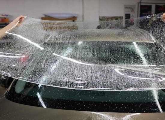 Auto glass cleaning and protection service in vehicle detailing.