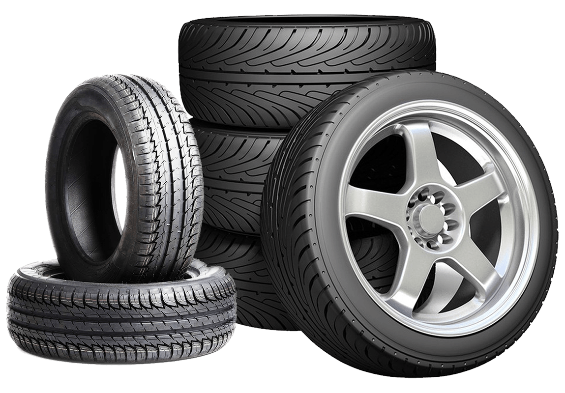Stack of new car tires and alloy wheel at Macy's Tire & Lube.