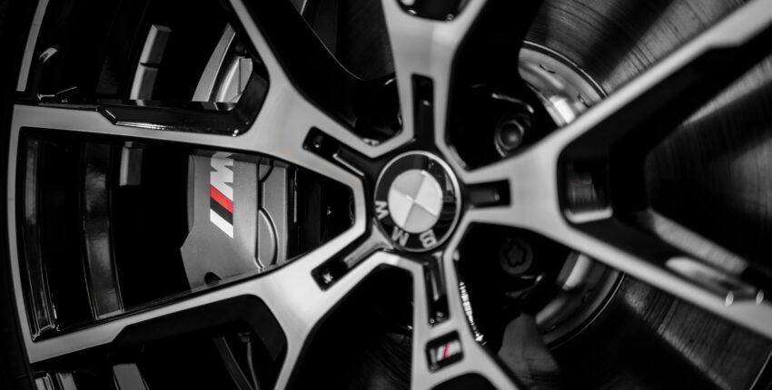 BMW wheel rim with M performance brake caliper, high-quality automotive repair.