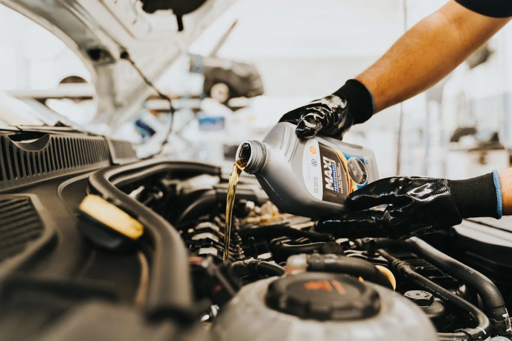 Trusted BMW mechanic performing an oil change on a vehicle.