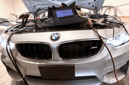 Automotive electrical diagnosis tools on BMW front for troubleshooting.