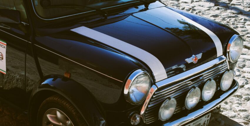 Vintage Mini Cooper with rally lights on snowy road in Vancouver.