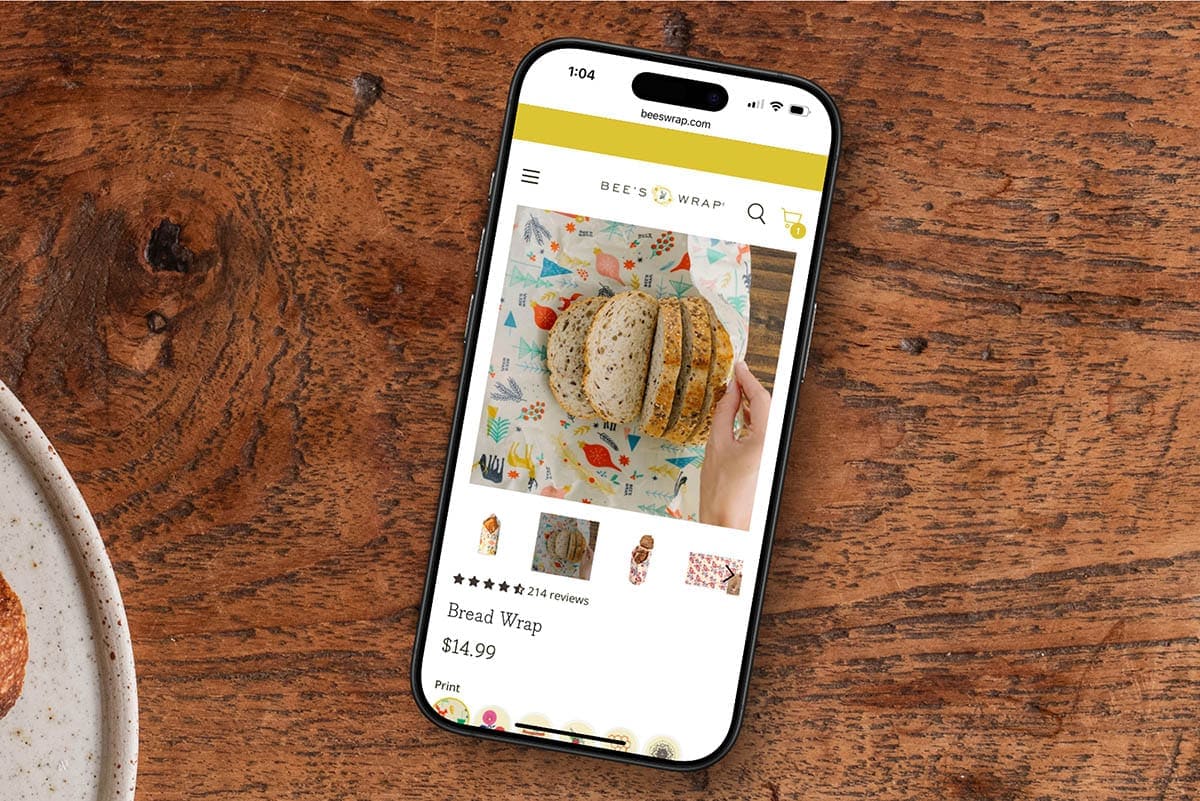 phone with an e-commerce website on a wooden table