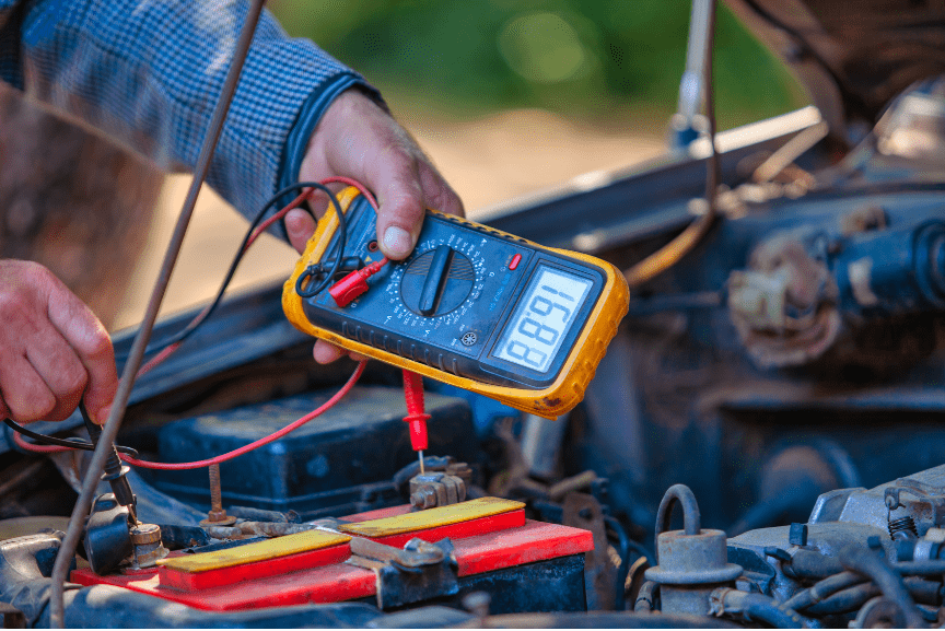 Car smog test being performed with digital multimeter.