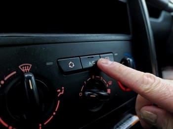 Climate control panel with temperature and airflow settings in a Mazda car.