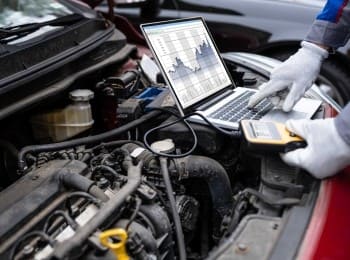 Automotive diagnostic testing using advanced tools for precise vehicle repairs.