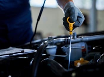 Engine oil change being performed on a vehicle at Mazda Pros Inc.