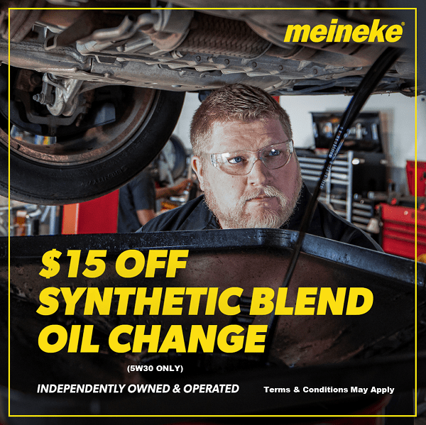 Mechanic performing synthetic blend oil change at Meineke Fresno.