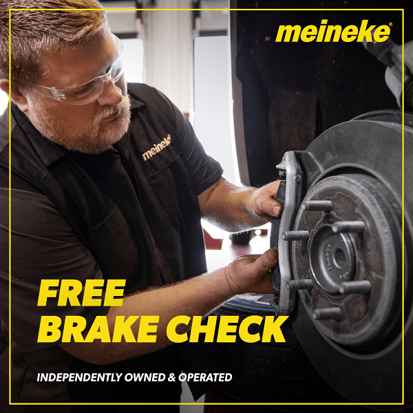 Meineke Fresno brake inspection service with technician checking brake system.