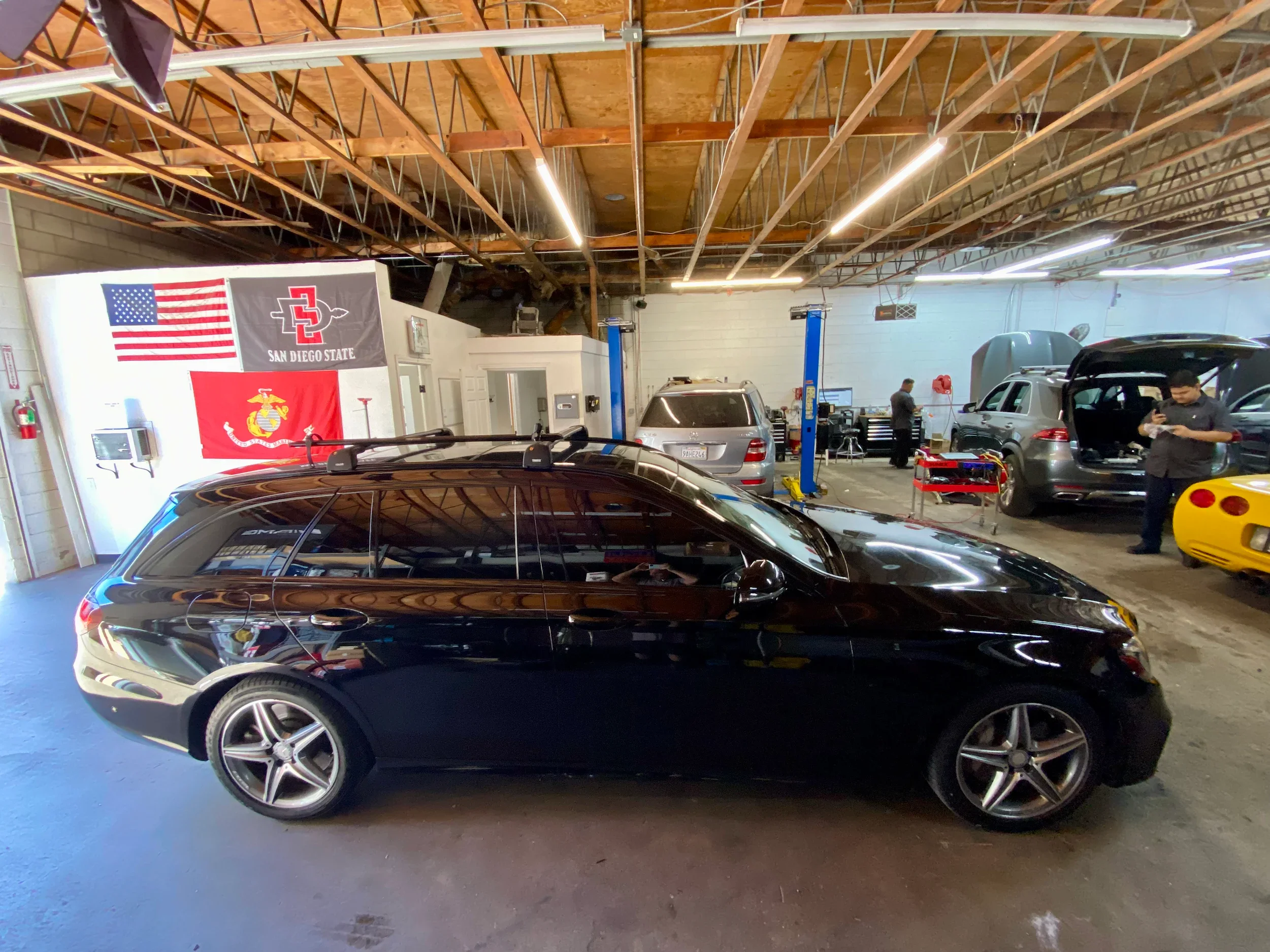 Luxury Mercedes-Benz vehicle in service bay for maintenance and repairs.