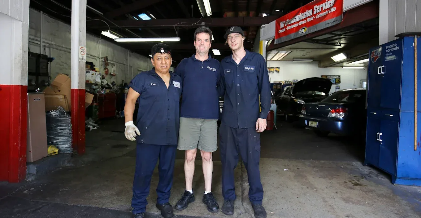 Mickey's Automotive team with technicians in garage.