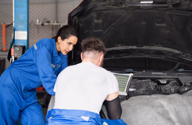 Team of professional mechanics at Mickey’s Automotive working on vehicle repair in workshop