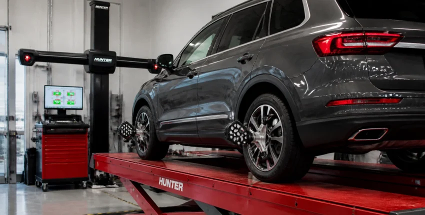 Vehicle on wheel alignment machine at Mickey's Automotive, Inc. for precise suspension and steering.