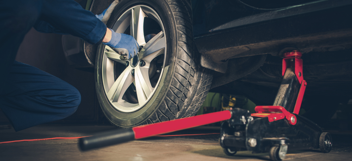 Technician servicing a tire on a balancing machine