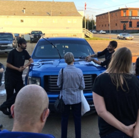 Minotaur Mechanical team inspecting a blue truck outdoors.