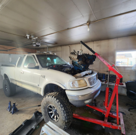 Vehicle repair in progress at Minotaur Mechanical with engine work underway.