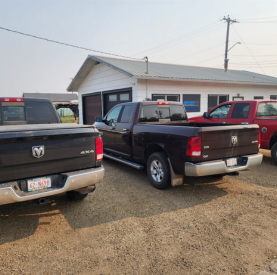 Multiple trucks parked outside Minotaur Mechanical workshop in Minotaur, ready for service.
