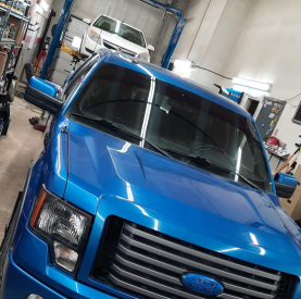 Blue service truck at Minotaur Mechanical workshop for maintenance and repairs.