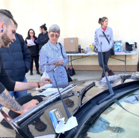 Minotaur Mechanical team providing car maintenance at community event.