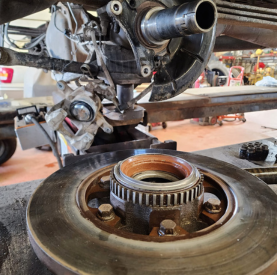 Close-up of engine transmission repair with tools and parts at Minotaur Mechanical.
