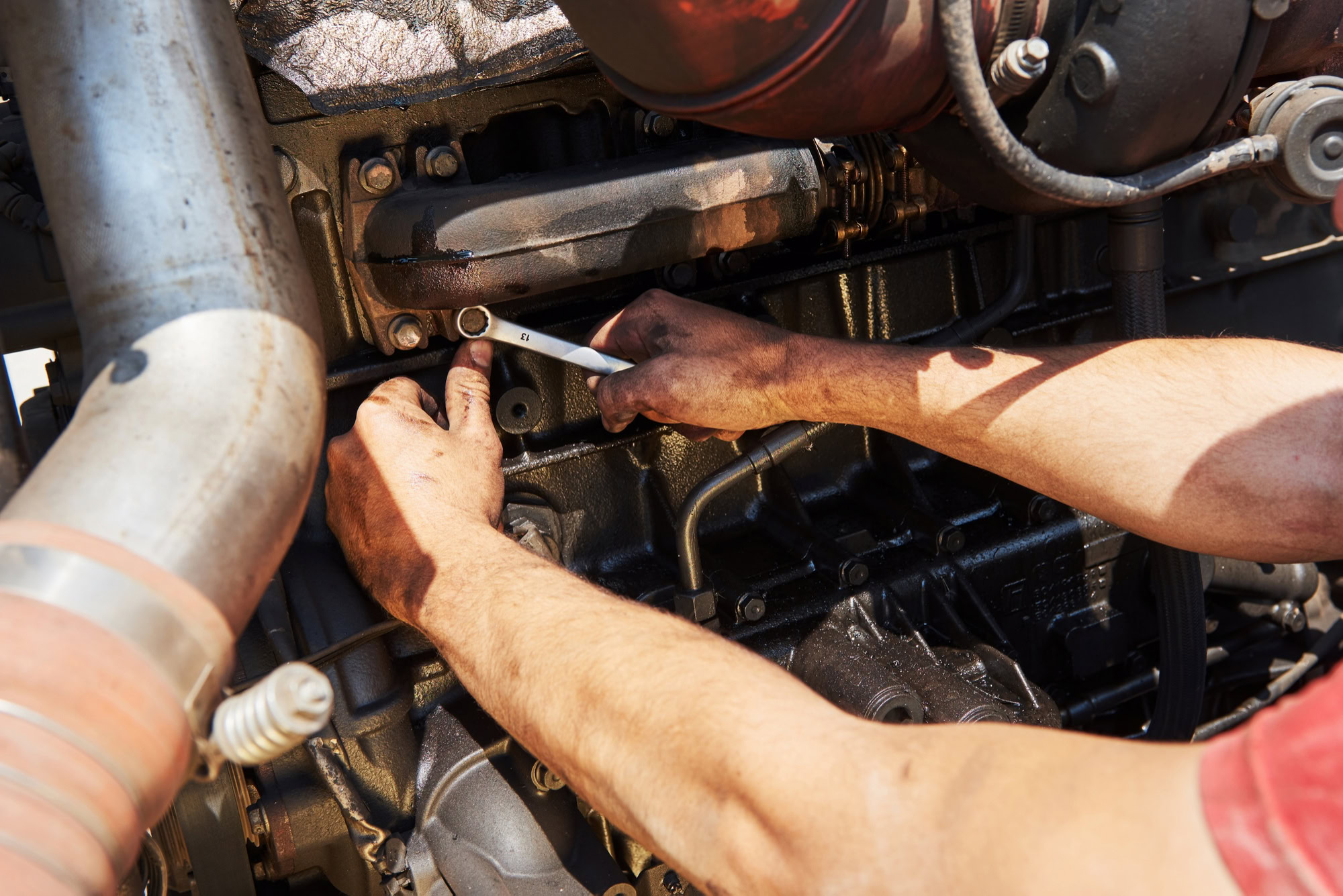 Technician repairing engine components during maintenance at Minotaur Mechanical.
