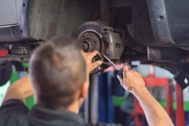 Mechanic repairing worn out brake plate